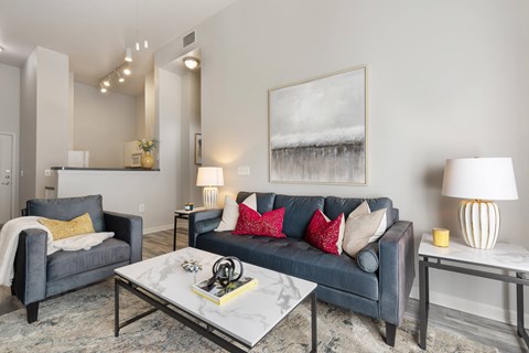 a living room with a blue couch and a coffee table